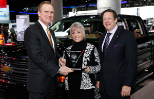 Lloyd Biermann, Silverado Marketing Manager accepts the 2014 Interntional Truck of the Year trophy for the Silverado. Presenting are Mike Martini, president Bridgestone OE America and ICOTY sponsor; and Courtney Caldwell, ICOTY founder and editor in chief Road & Travel Magazine